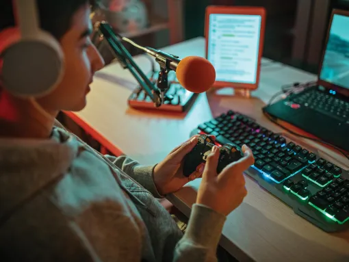 Teenager playing multiplayer online games at home