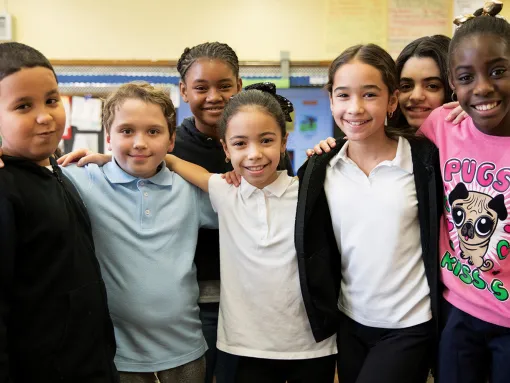 5th graders posing for a group shot in their classroom
