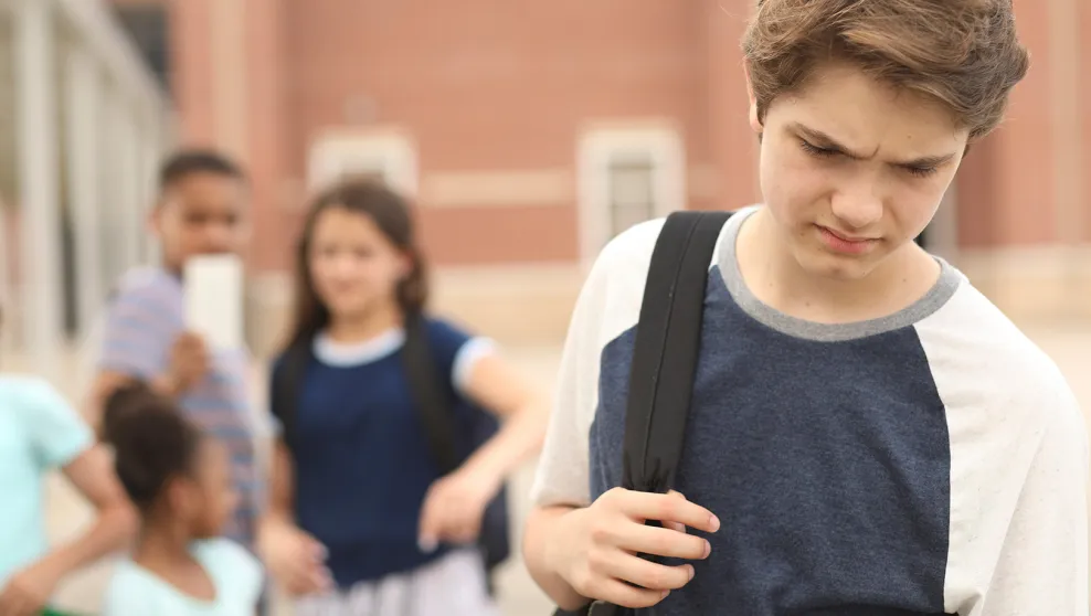 Teen boy being bullied by peers